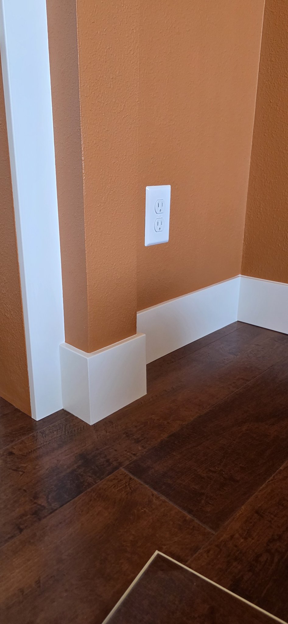 Baseboard scribed tight to the floor at a corner in Missoula