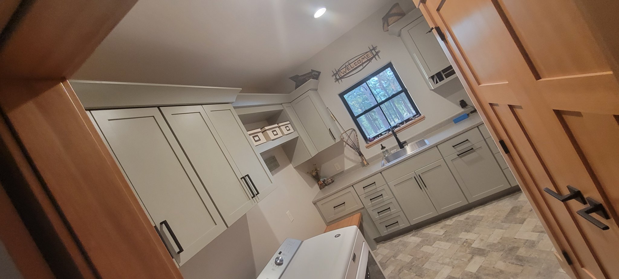 Mudroom with gray shaker cabinets installed level and plumb